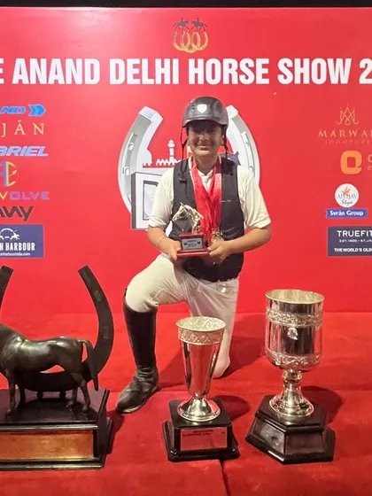 A junior rider surrounded by his trophies from the Delhi Horse Show. We provide the platform for young, ambitious riders to achieve their goals.