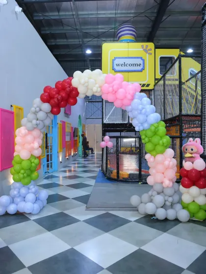 A colorful balloon arch welcomes guests to the Labubu party, with a mix of soft and bright colors to match the theme's aesthetic.