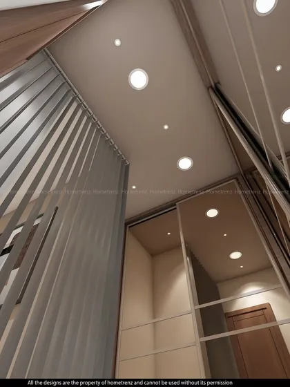 A low-angle view of a partition and mirrored wardrobe, showing the interplay of light and reflection from the ceiling spotlights.