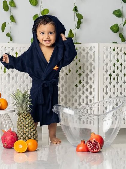 All clean and wrapped up in a cozy robe after his splash session. This is the perfect way to end a fun-filled photoshoot.