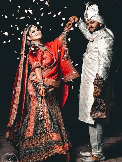 A wedding is a celebration, and I love capturing that dynamic energy. This shot of the couple during their wedding portrait session, with a shower of petals, freezes a moment of pure happiness and movement.