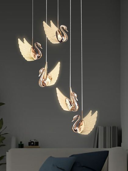 The swan pendants create a magical, floating effect, perfect for a modern and artistic interior.