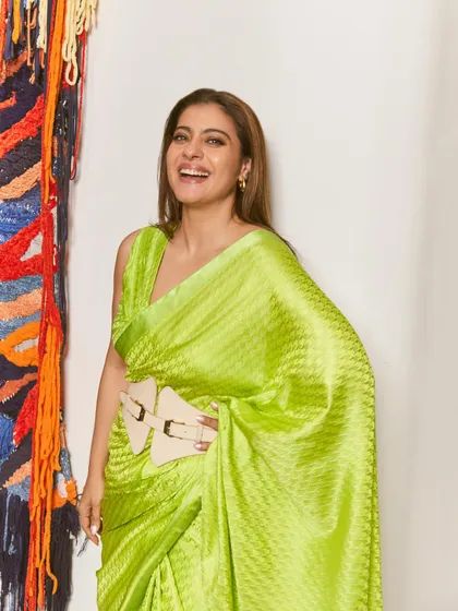 A closer look at the modern belted silhouette of the lime green saree, showcasing a fun and contemporary way to style the garment.