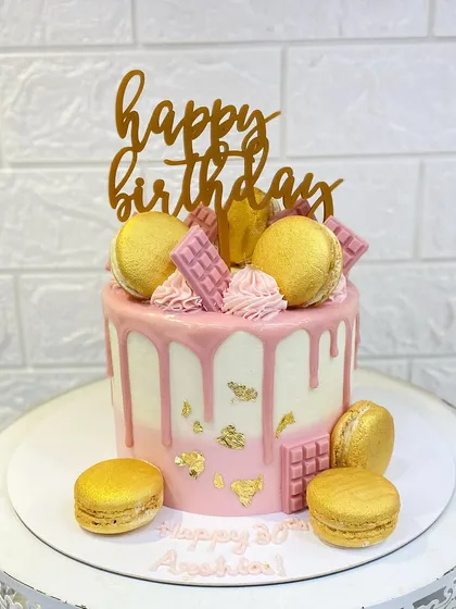 I love creating elegant centerpiece cakes like this one. This pink drip cake with gold leaf accents and handcrafted macarons is perfect for a special birthday. Every detail is made with care to make your celebration unforgettable.