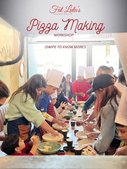 A glimpse into one of my pizza making workshops, where everyone gathers around to get their hands in the dough. It's a fun, interactive group setting perfect for learning and socializing.