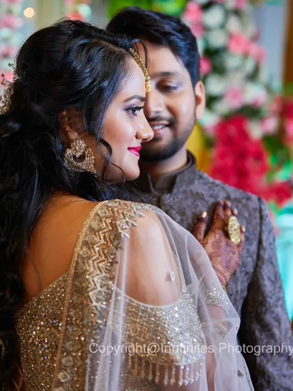 This candid close-up captures a look of affection from the bride towards her groom during their reception. The soft lighting and blurred background create a romantic feel.