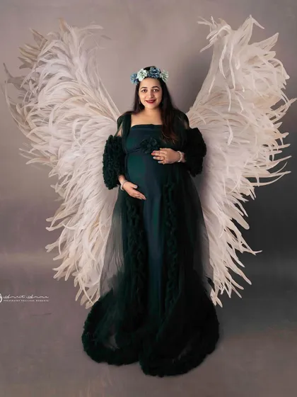 An ethereal and powerful portrait. The combination of the dark green gown and the large white angel wings creates a stunning contrast and a truly memorable image.