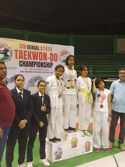Young female competitors on the podium at the 5th Bengal State Taekwon-Do Championship.