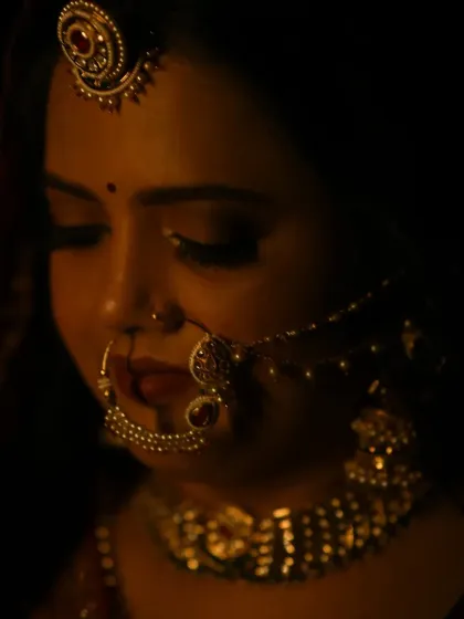 A candid moment captured under warm lighting. You can see how the makeup creates a soft glow on the skin, ensuring you look perfect from every angle, even in low light.