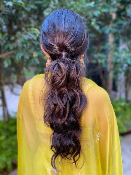 The back view of the low ponytail shows its simplicity and grace. It's a timeless look that never goes out of style.