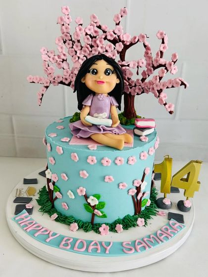 A beautiful cake for a 14-year-old who loves reading under a cherry blossom tree, all recreated in fondant.