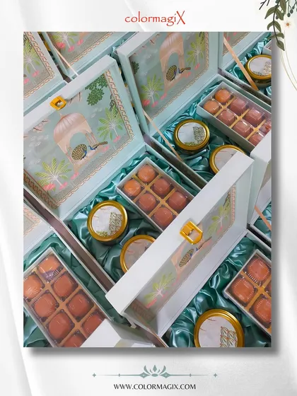 The wedding season is here, and our hampers are ready. This collection of elegant pastel green boxes with a clear lid showcases motichoor laddus and decorative jars, perfect for wedding announcements.