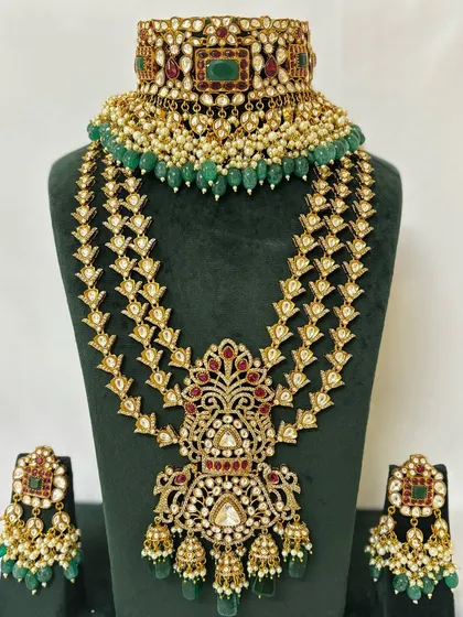 A full view of a grand bridal set with a multi-layered necklace and matching choker. This rental piece is perfect for a royal wedding look.