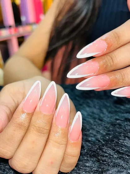 Clean, sharp, and absolutely timeless. This is my take on the classic French manicure, sculpted into a flawless stiletto shape. It’s a perfect example of the precision and attention to detail I bring to every set.