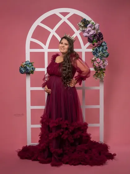A full-length shot showing the couple in one of my studio setups. The mother-to-be looks radiant in her gown, complemented by her partner standing proudly by her side.