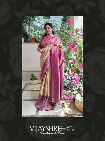 Ramadevi in her garden, the natural light beautifully highlighting the rich texture of her brocade saree.