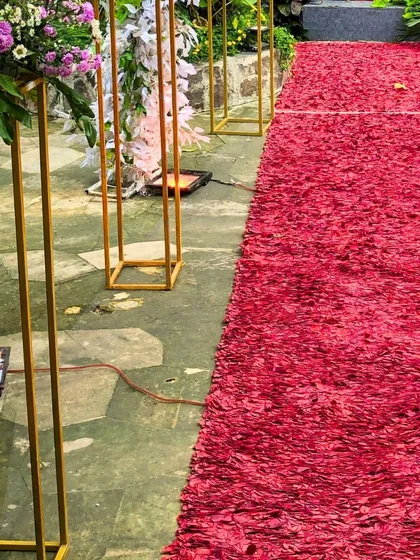 The entrance sets the tone for the entire event. For this occasion, I designed a dramatic entry path using a carpet of red rose petals, flanked by elegant floral stands. It’s these small, thoughtful details that create a grand and memorable welcome for every guest.