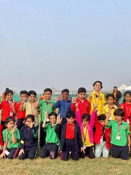 A class poses for a group picture, capturing the shared joy and camaraderie of their day at the adventure camp. These experiences foster friendships and create cherished memories.