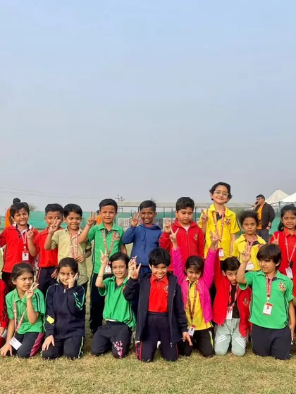 A class poses for a group photo at the adventure camp, full of smiles and energy. These outings are a fantastic way for students to bond with their classmates and teachers.