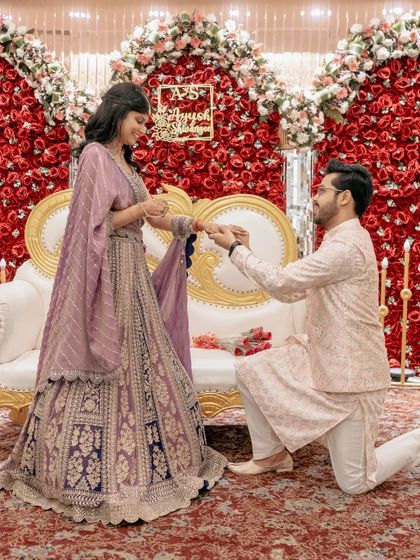 A slightly different angle of the proposal, showing the bride's happy reaction as she accepts the ring.