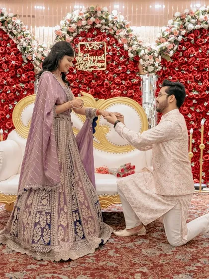 A slightly different angle of the proposal, showing the bride's happy reaction as she accepts the ring.