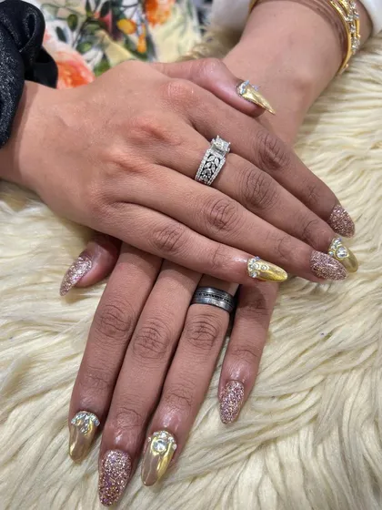 Another angle of the gold and glitter manicure, showing off the intense sparkle and shine. This is a perfect choice for a bride or a major celebration.