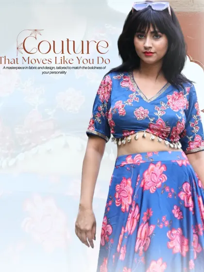I love creating vibrant, modern lehengas perfect for a mehendi or sangeet. This custom-printed floral set in blue and pink features a stylish V-neck blouse with playful shell tassels for a fun yet elegant look.
