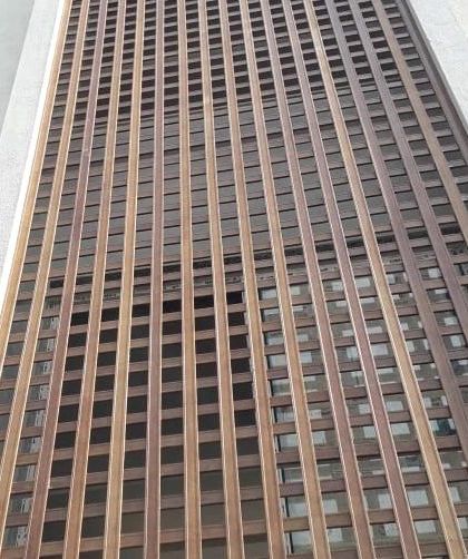 A full view of the building facade using Tipwood louvers. This demonstrates our ability to cover extensive surfaces with a product that looks like real wood but offers superior durability and lower maintenance.