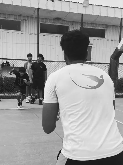 Grinding every day, getting closer to dreams. A coach observes a player during an agility drill, a quiet moment of focus amidst the intense training.