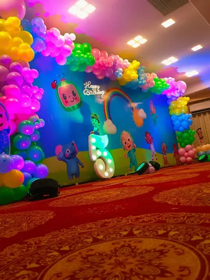 A dynamic view of the Cocomelon party decor with colorful lighting.