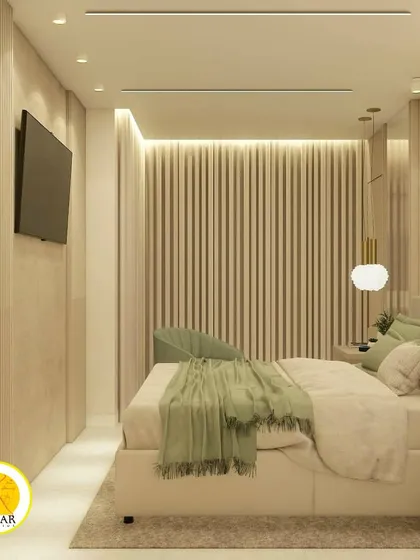 A serene bedroom with a soft green and beige color palette. The wall behind the bed features vertical fluting, adding texture and depth.