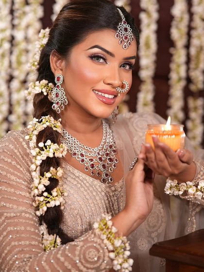 This festive look is perfect for a pre-wedding event. The makeup is soft and glowing, with a focus on radiant skin, a classic winged liner, and a beautiful smile.