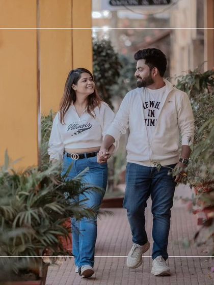 A candid shot of the couple strolling through the charming streets of Goa. Their casual outfits and happy smiles make this feel like a stolen moment from a romantic getaway.