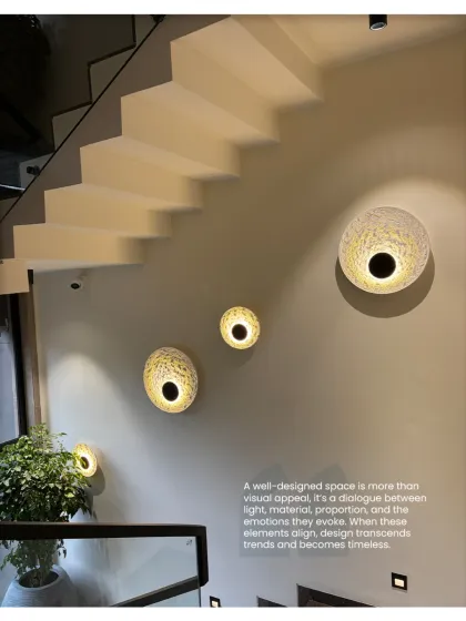 A well-designed space is a dialogue between light, material, and proportion. This staircase wall features sculptural light fixtures that create an emotional and timeless quality.