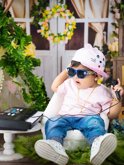 This cool toddler is listening to some tunes on his keyboard, showing off his rockstar style.