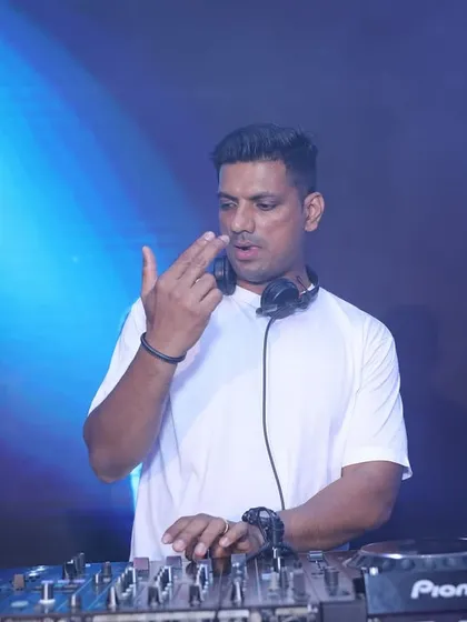 Cueing up the next track while keeping an eye on the dance floor. Reading the crowd's energy is essential for any successful DJ set.