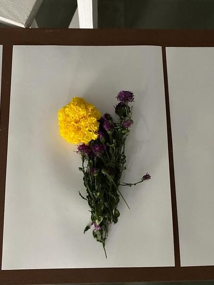 A floral arrangement on paper, created by a visitor during the live art performance.