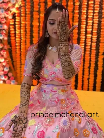 Another angle of this classic bridal pose, highlighting the detailed henna work.