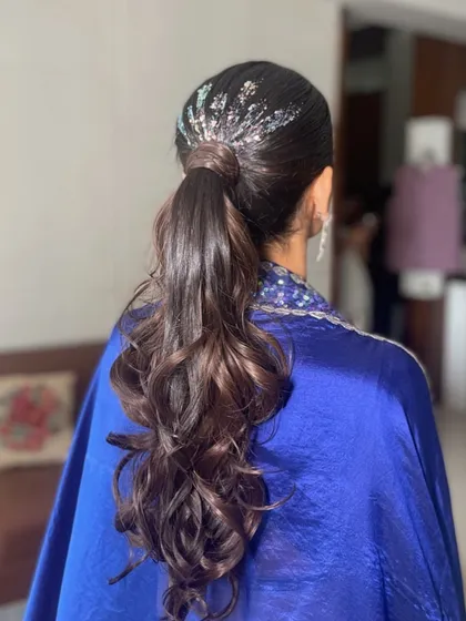 A sleek ponytail with a touch of silver glitter at the base. This is a great look for a cocktail party or a New Year's Eve event, adding instant glam.