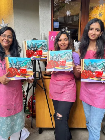 Three participants with their cozy Christmas themed paintings. These workshops are a great way to get into the holiday spirit.