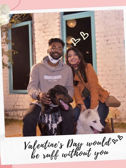 Valentine's Day would be 'ruff' without you. A couple poses with their two dogs, a perfect family portrait.