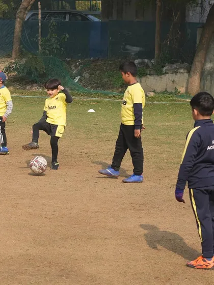 Young players watch a demonstration. Our training is personalized and age-appropriate, ensuring every child understands the fundamentals before moving on.