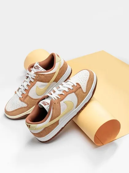 We used rolled paper and a soft, neutral color palette to create a stylish and architectural setting for these sneakers. The composition is clean and modern, highlighting the shoe's texture and design.