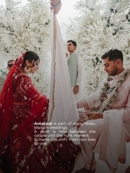 The Antarpat ritual, a sacred part of many Hindu weddings, marks the moment two lives become one. We ensure our ceremony designs provide a beautiful and respectful space for such traditions, like this moment captured against a wall of white florals.