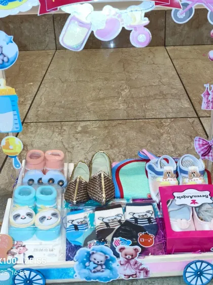 A cart full of baby shoes and socks for twins, showcasing a variety of styles for both a boy and a girl.