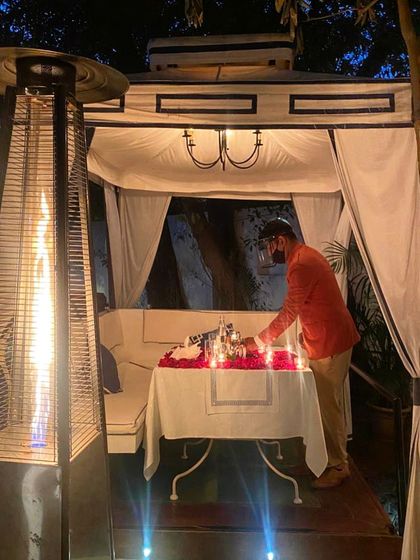 My team and I take great care in setting up each romantic dinner. Here, a staff member adds the final touches to a candlelit table.