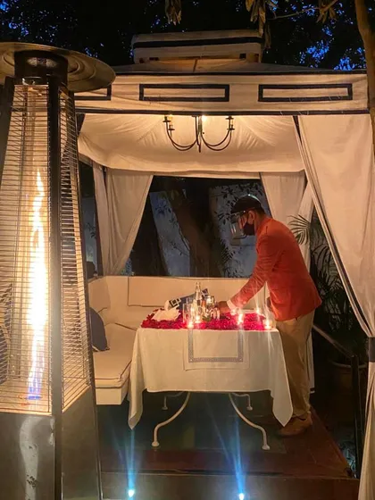 Our staff takes great care in preparing every detail, here seen arranging a romantic table setting in one of our private cabanas.