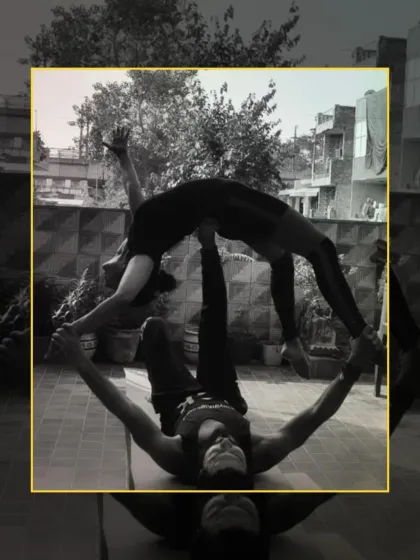 A stunning black and white shot of a partner backbend in acro yoga, highlighting the lines, strength, and trust between the base and flyer.