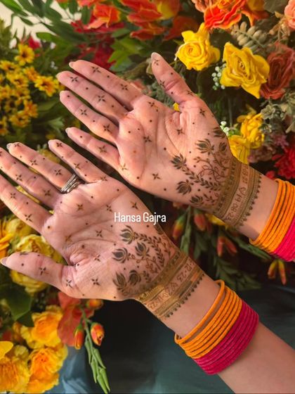 A close-up of a minimal floral design. The pattern features a simple wristband and delicate vines extending onto the palm, leaving plenty of open space for an airy and elegant feel.