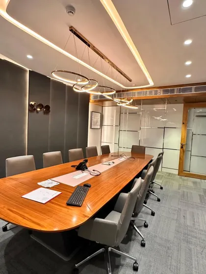 A view of the boardroom showing the integration of glass walls, which allows for a visual connection to the rest of the office while maintaining privacy. The design balances openness with the need for a focused meeting environment.